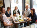 Fünf Personen, jüngere und ältere Menschen sitzen in der Kaffee-Ecke im „Aidhäuser „Dorflädle“